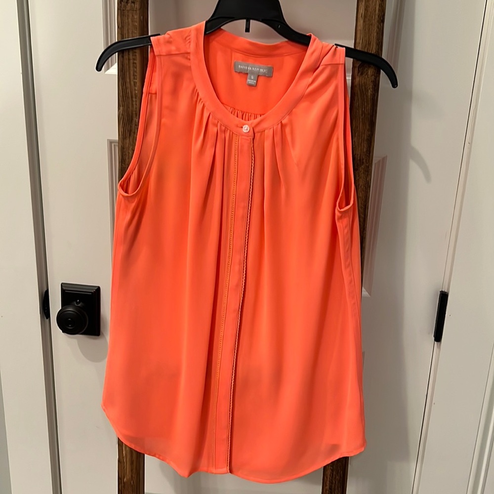 Neon orange flowy top.